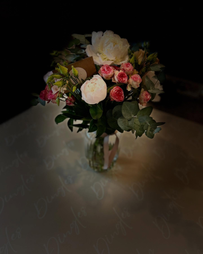 Pink Clouds - This dreamy vase arrangement promises to make a lasting impression! Comprised with only the finest peonies along with an entourage of roses. Delivered in a pink and white colourway with complimentary foliage.