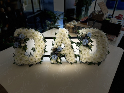 Letter Tribute - A classic and elegant funeral letter tribute, thoughtfully designed using fresh white chrysanthemums to create a full and soft base