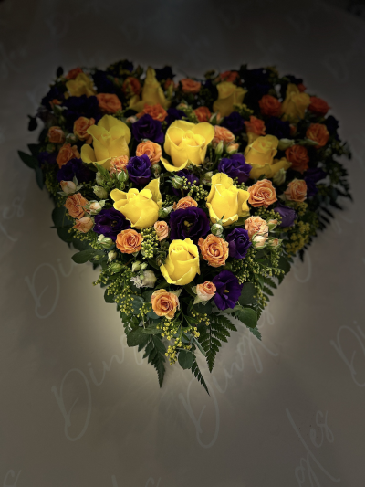 Heart-Shaped Funeral Tribute - A heart-shaped funeral tribute, beautifully arranged with a vibrant mix of fresh flowers in warm and uplifting tones.