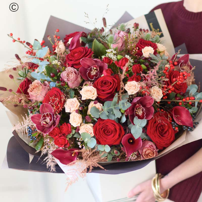 A Christmas Showstopper Bouquet - A quick rundown: our biggest Christmas bouquet, this one promises to be an astonishing mix of the best fresh festive flowers, expertly chosen by a Dingles Florist.

Colour & style: festive favourites. Rich reds, burgundies and greens. Pops of cream and peach. You might see coppery painted pinecones, scented dried fruit, spruce and pine.

A great gift for: taking the Christmas decor to the next level, wowing a loved one, sweeping someone off their feet

All the other details:
• This will be handcrafted by a Dingles Florist, who will use all their care and skill and make sure it arrives ready to wow.
• It might not look exactly like the pictures because each bouquet is bespoke, made by hand.
• It's guaranteed to look gorgeous for at least 7 days, or we'll put it right.
• It could feature buds, but they'll open up quickly.
• The packaging is all recyclable or biodegradable.
• It comes with a lovely card, the florist will add your message inside by hand.
• If you have any special requests (like pet-friendly flowers or no lilies), there's a space to add them before you check out. The florist will try their best to help.